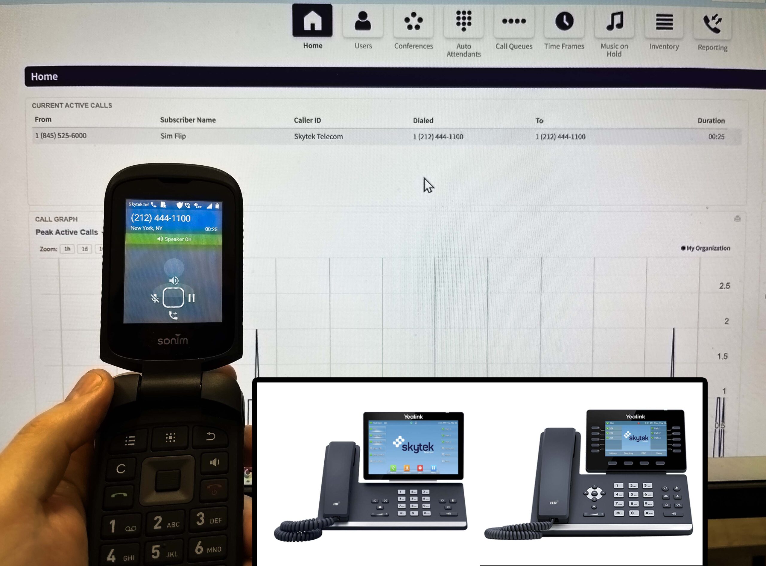 A flip phone held in hand beside Skytek desk phones